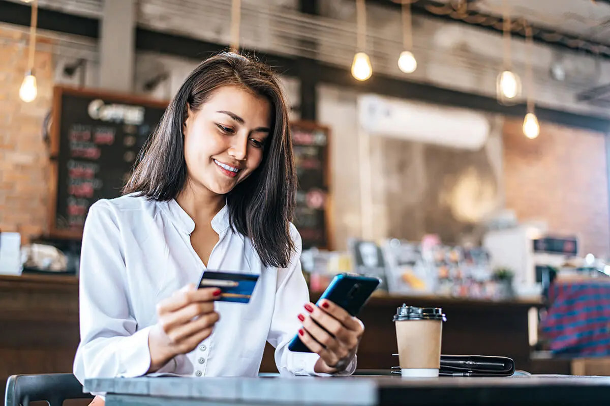 A woman smiling because she got credit cards for non us citizens