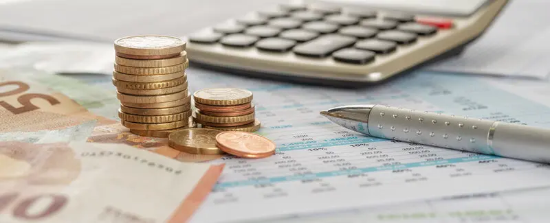 A calculator and some change used to represent a bank account someone can get without an SSN