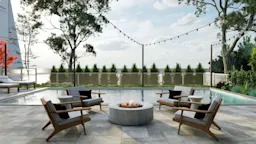 Poolside lounge area with modern wooden chairs and round firepit, string lights overhead, and a landscaped backyard.