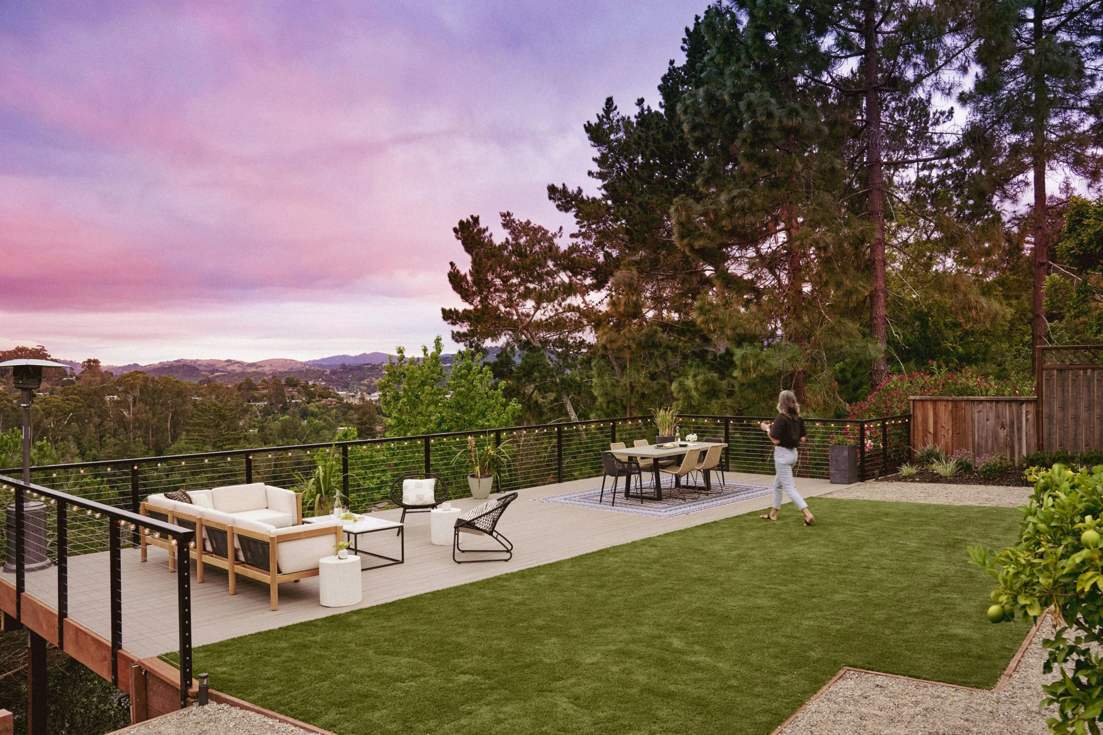 Woman on elevated deck overlooking skyline.