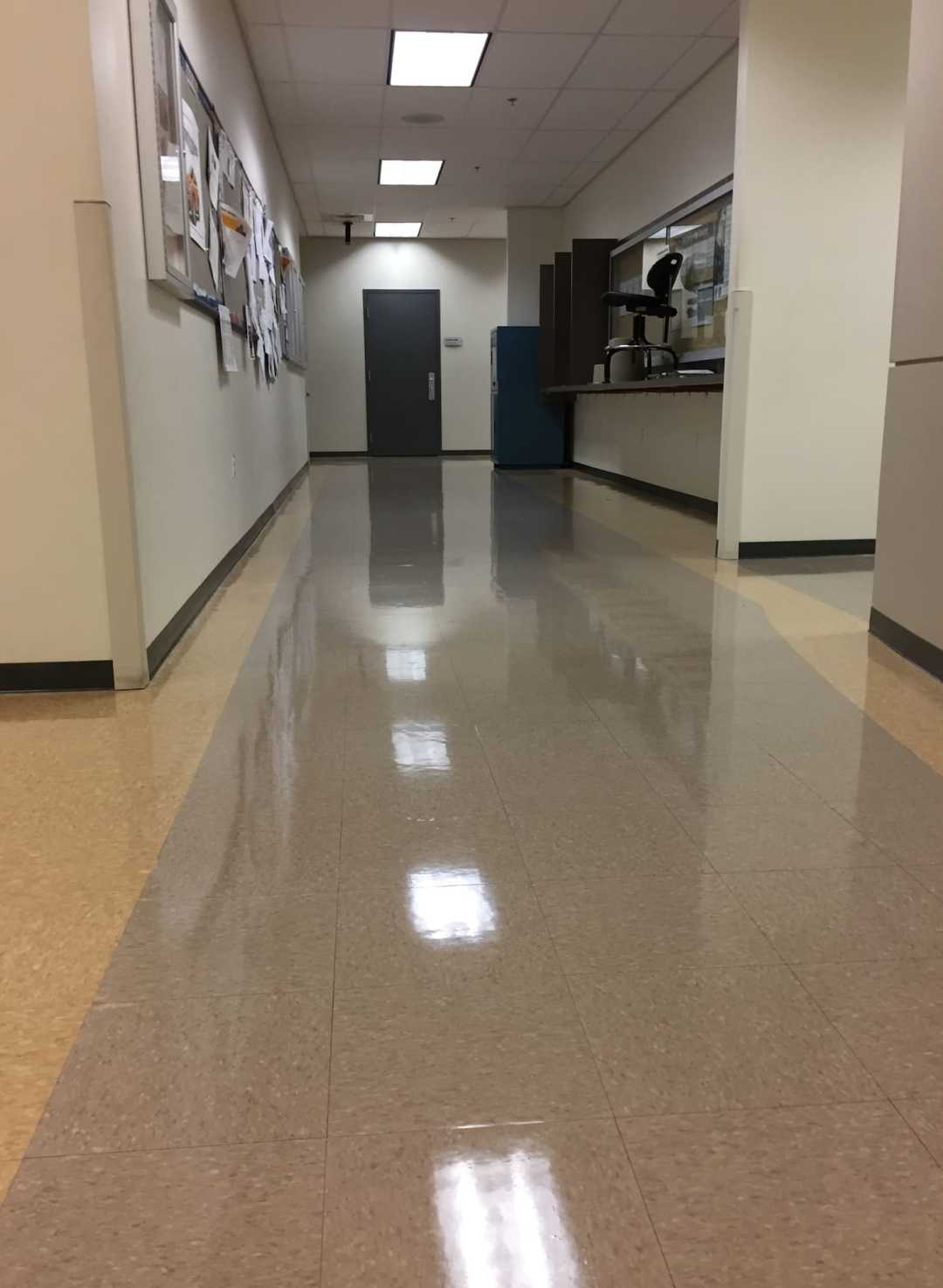 lights reflecting off polished hallway floor.