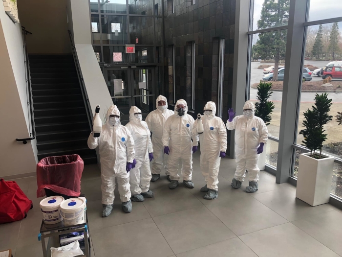 group of cleaning experts in protective equipment.