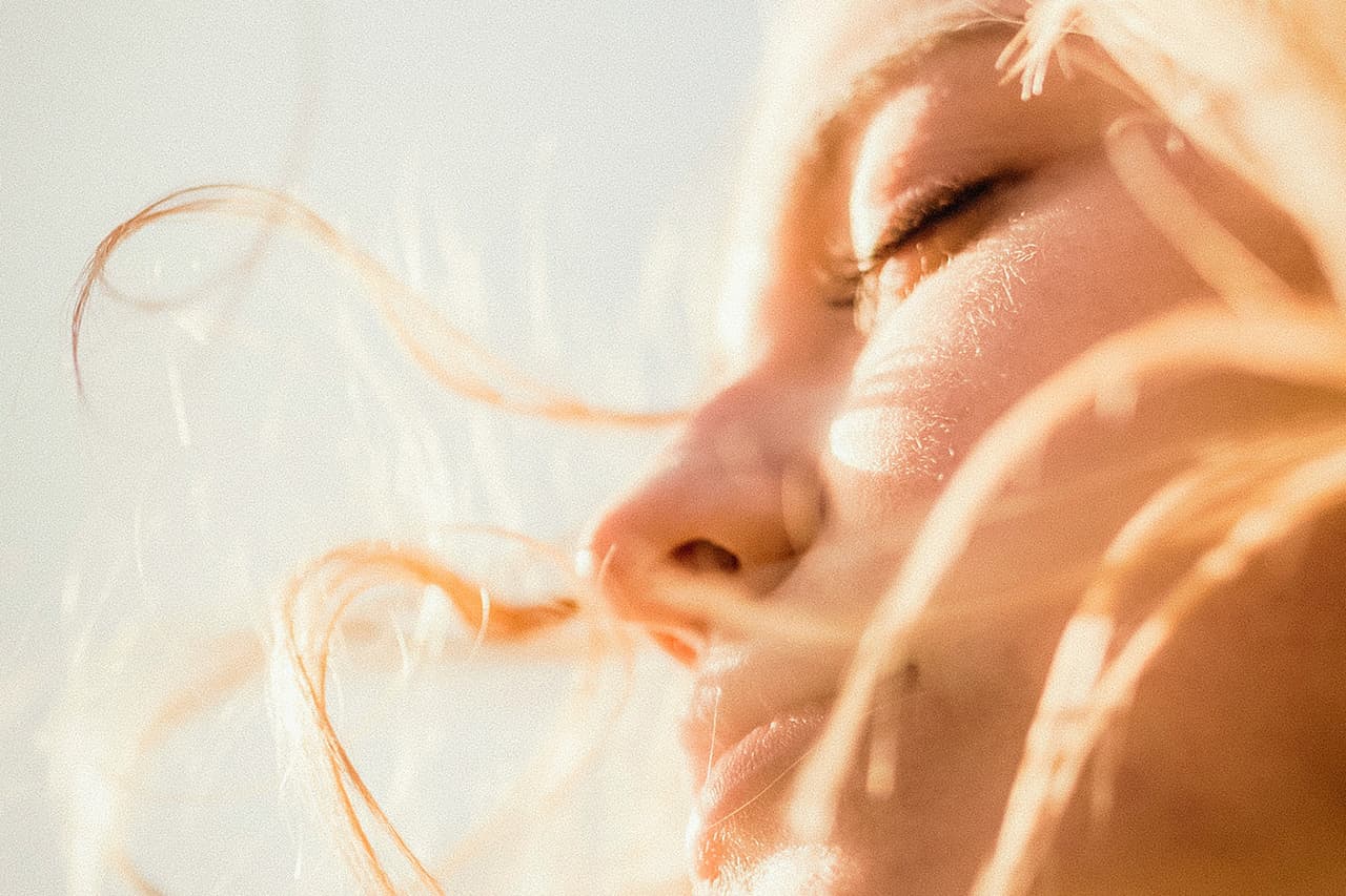 Woman enjoying warm sunlight