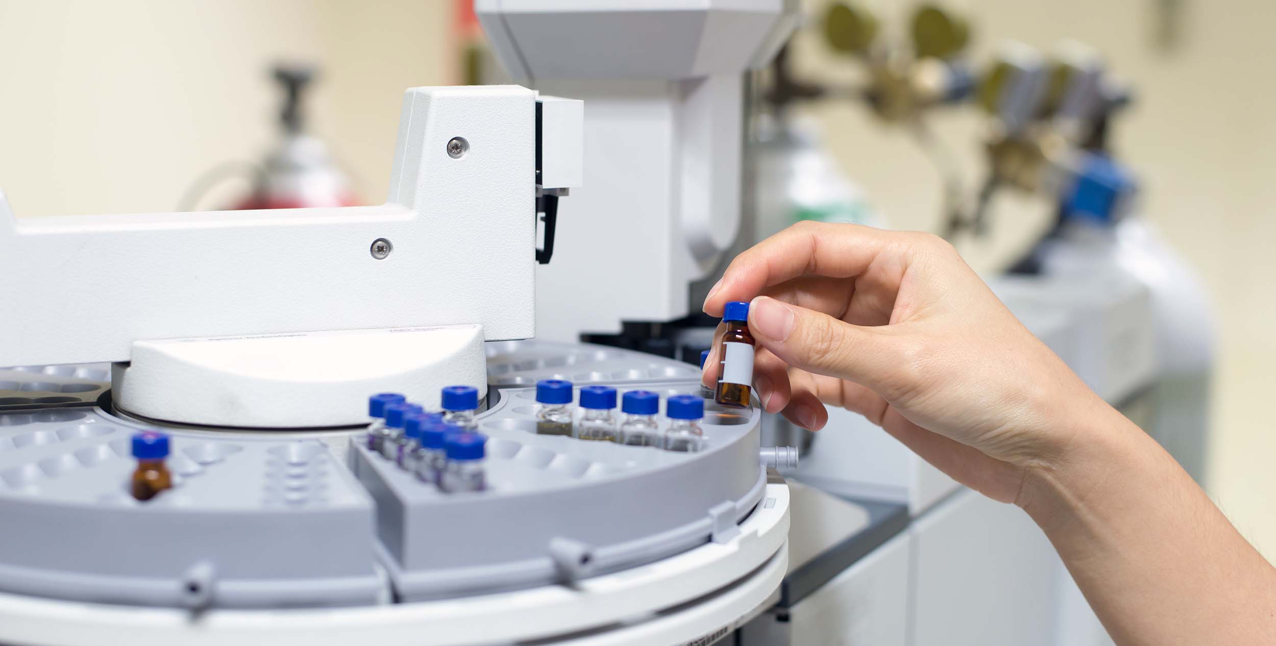 scientist holds an amber vial