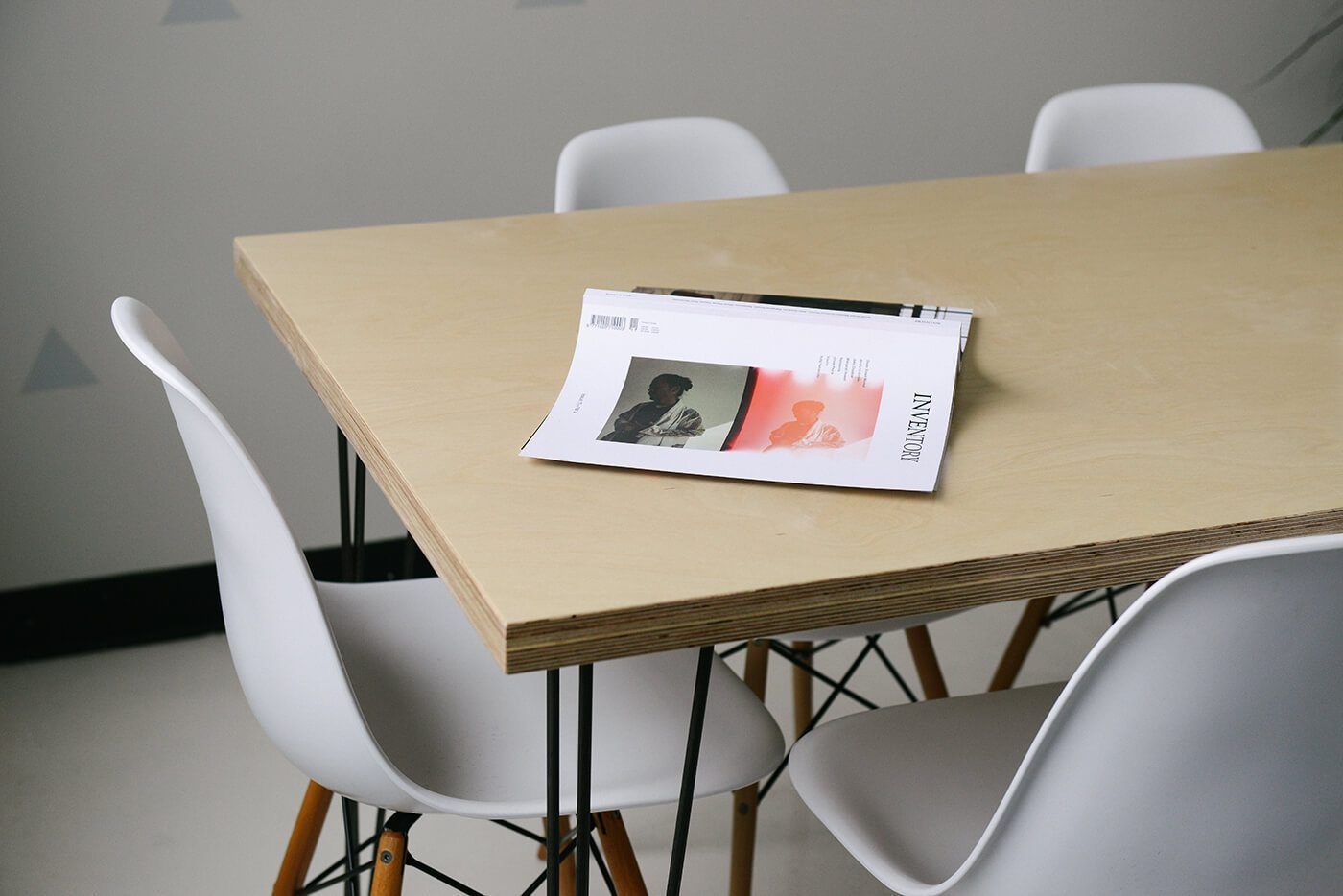 A wooden table and white chairs