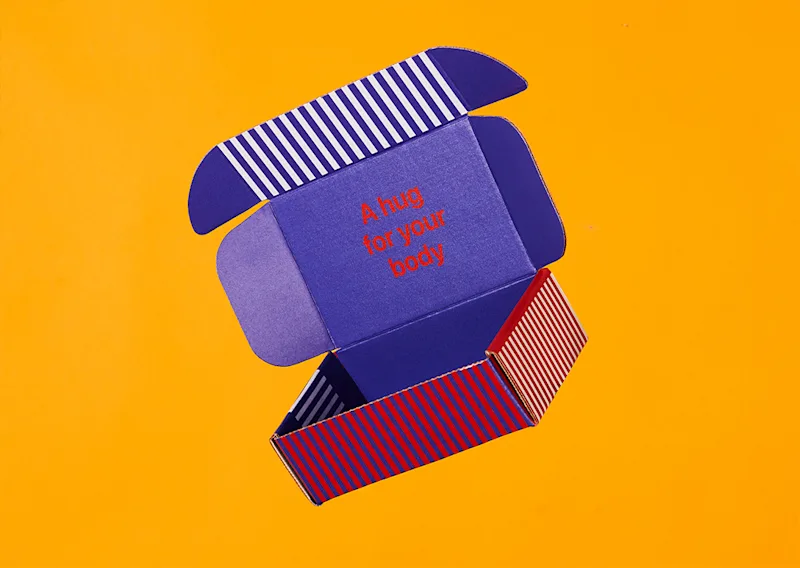 Open custom printed mailer box by Packwire showing the roll-end tuck-front structure and inside printing