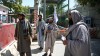 Taliban fighters stand guard at an entrance of the green zone area in Kabul