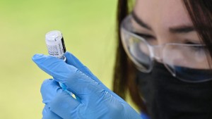 A healthcare worker fills a syringe with Pfizer Covid-19 vaccine at a community vaccination event in California.