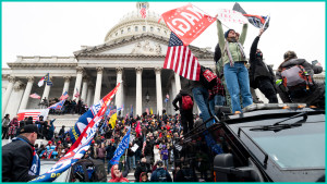Trump supporters stand on the U.S. Capitol Police armored vehicle as others take over the steps of the Capitol 