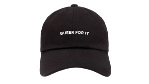 black baseball cap with words "queer for it"