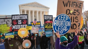 Demonstrators gather in front of the U.S. Supreme Court as the justices hear arguments in Dobbs v. Jackson Women's Health, a case about a Mississippi law