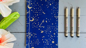 constellation-themed blue journal with blank pages
