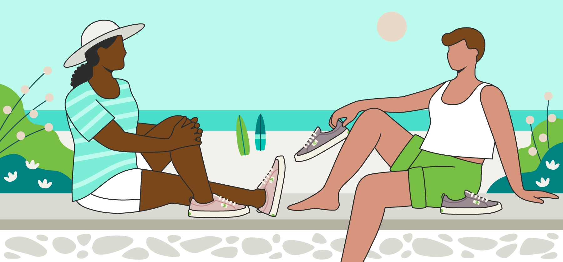Two women at beach wearing Cariuma sneakers