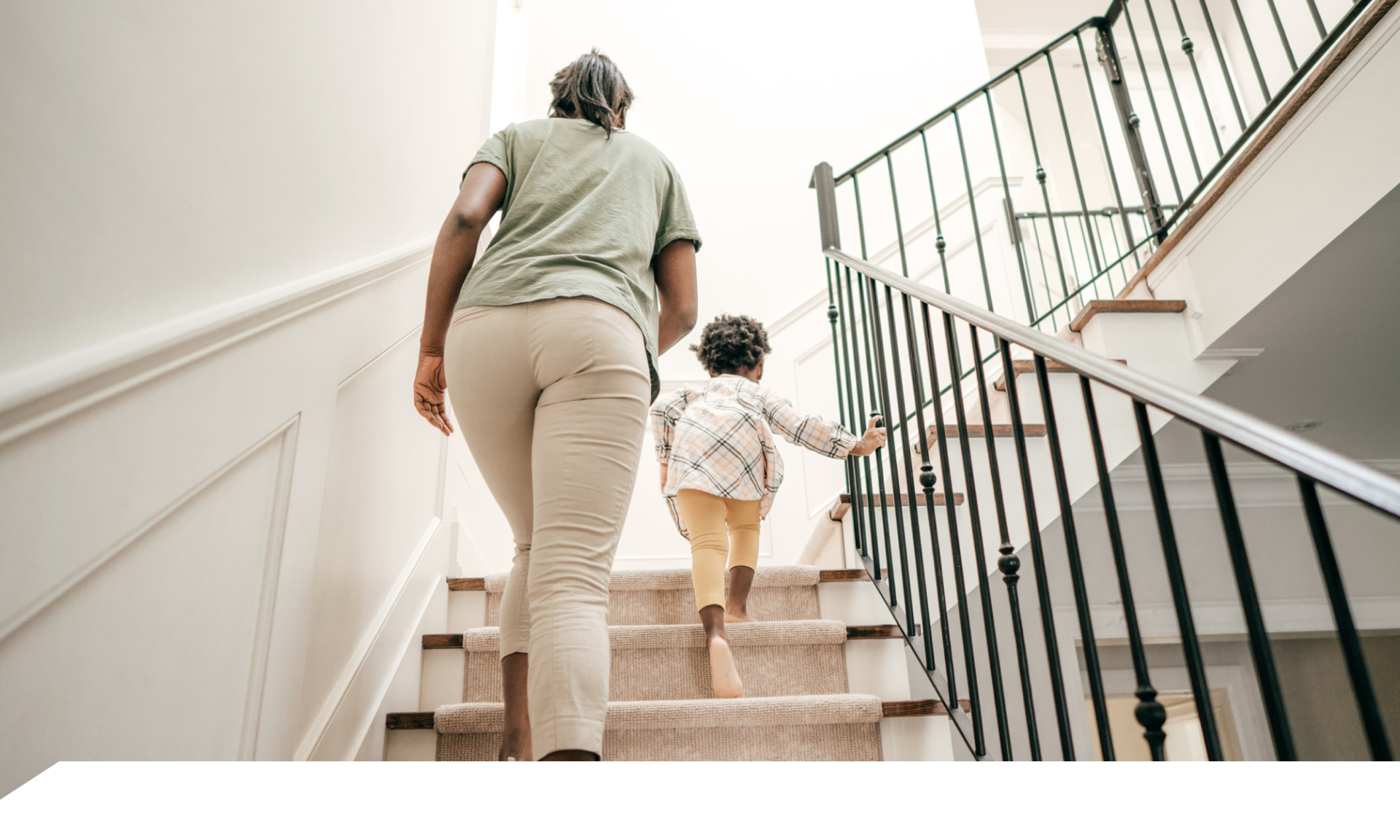 A woman walking up stairs holding a coffee cup