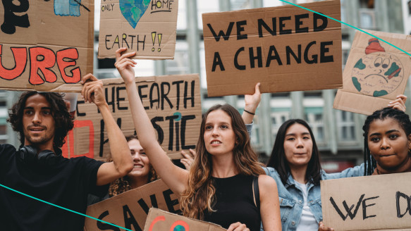 Protesters holding signs during a climate change rally