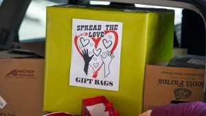 A box with gift bags and a sign that reads "Spread the love. Gift bags."