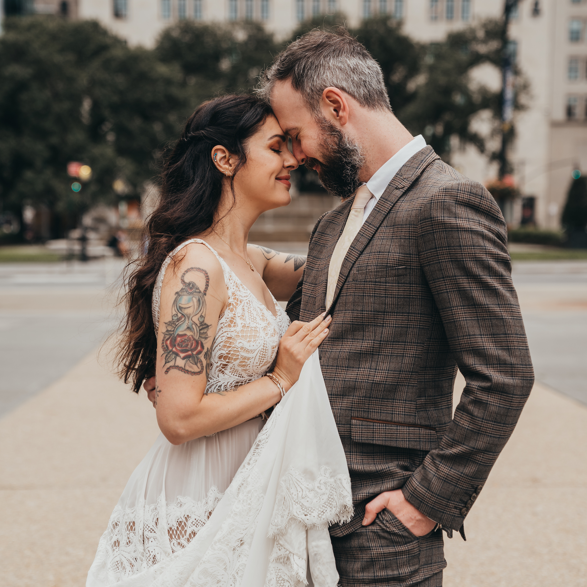 Couple touching foreheads in formal wear outdoors during a free Shoott professional photography session