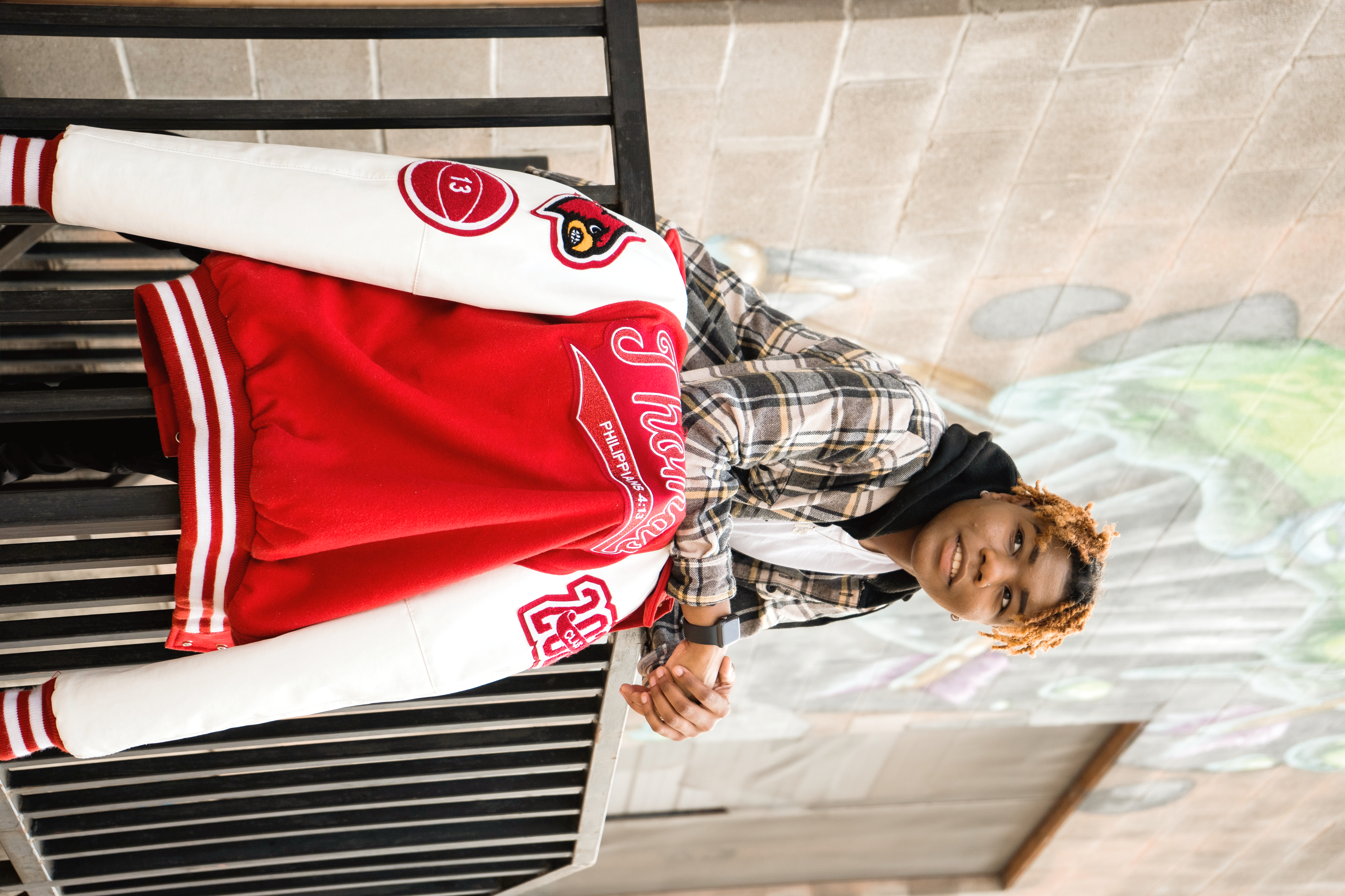 High school senior in an urban setting wearing a textured fall layer by a Shoott photographer.