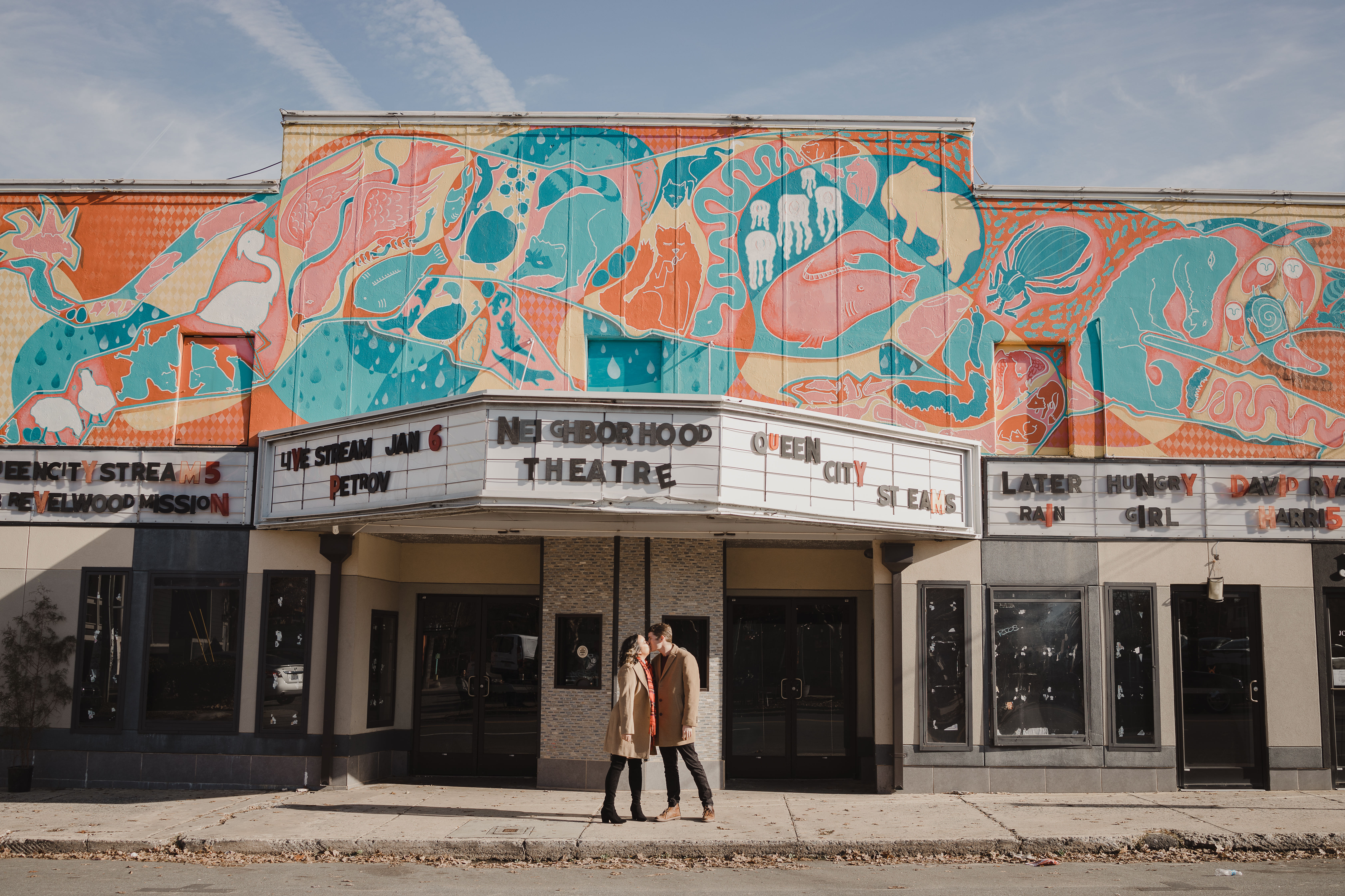 Colorful murals and historic storefronts in Charlotte's NoDa Arts District during an outdoor Shoott portrait session.