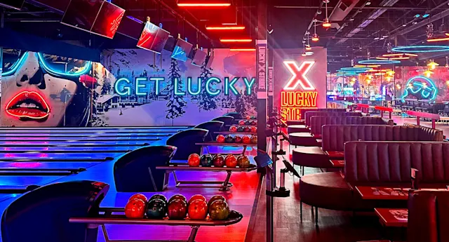 Colorfully lit bowling lanes and large, cushioned booths