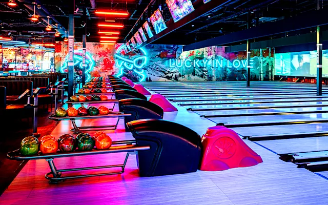 Lucky Strike bowling lanes with neon signs in the background.