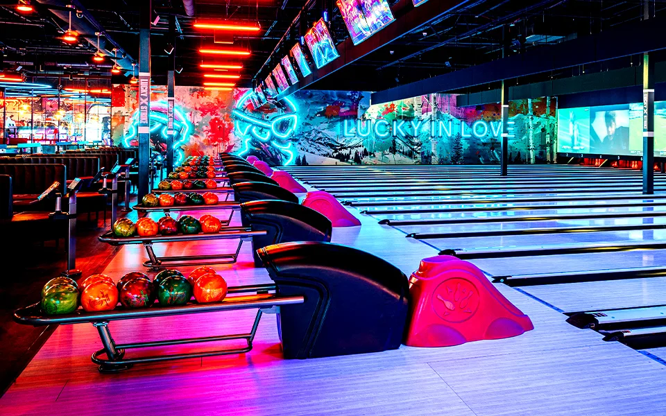Lucky Strike bowling lanes with neon signs in the background.