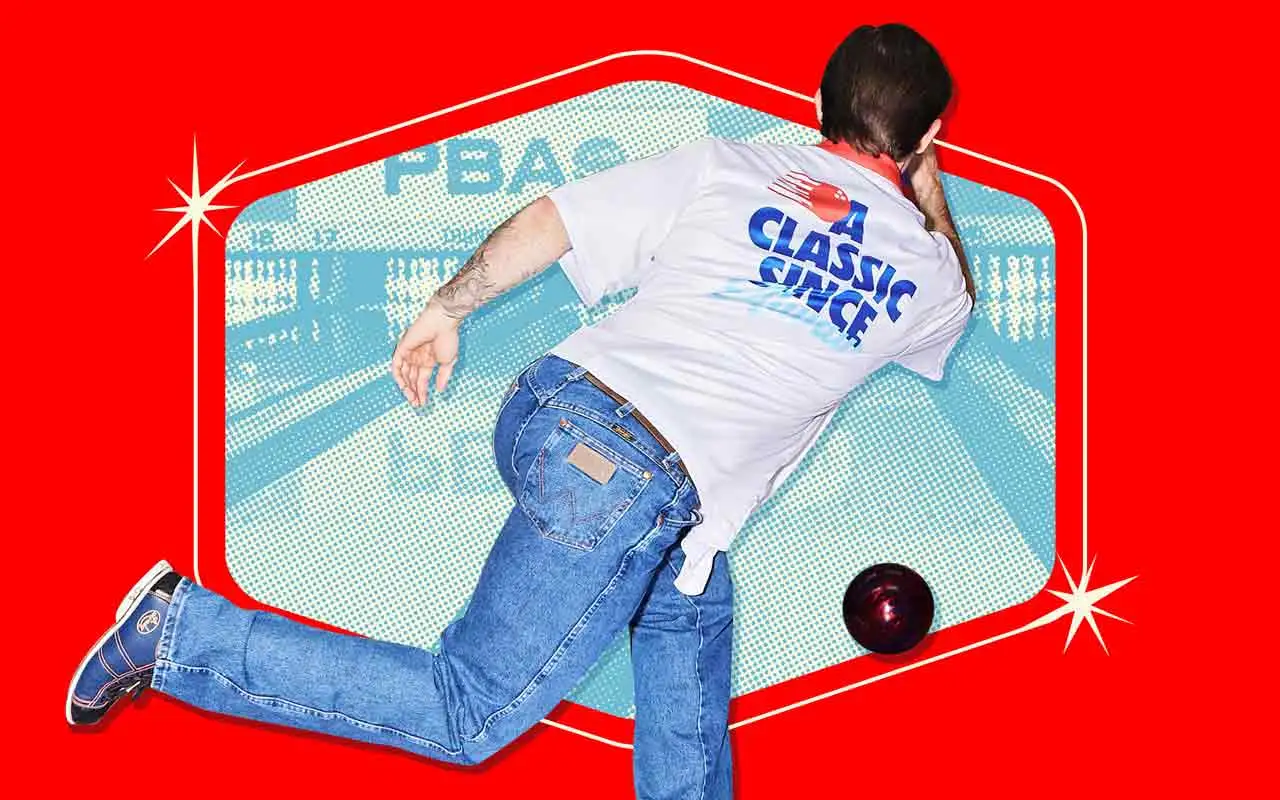 Man throwing a bowling ball down a lane.