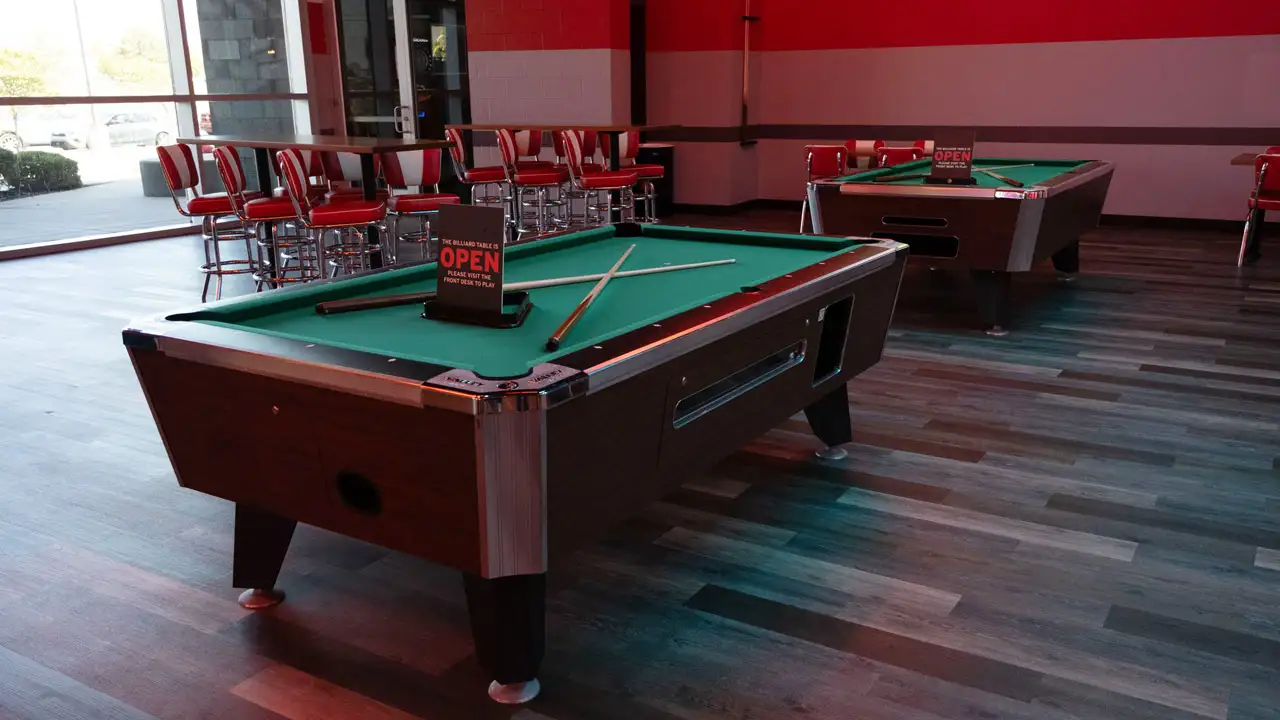 Beautiful billiards tables in a large room with tables and seating
