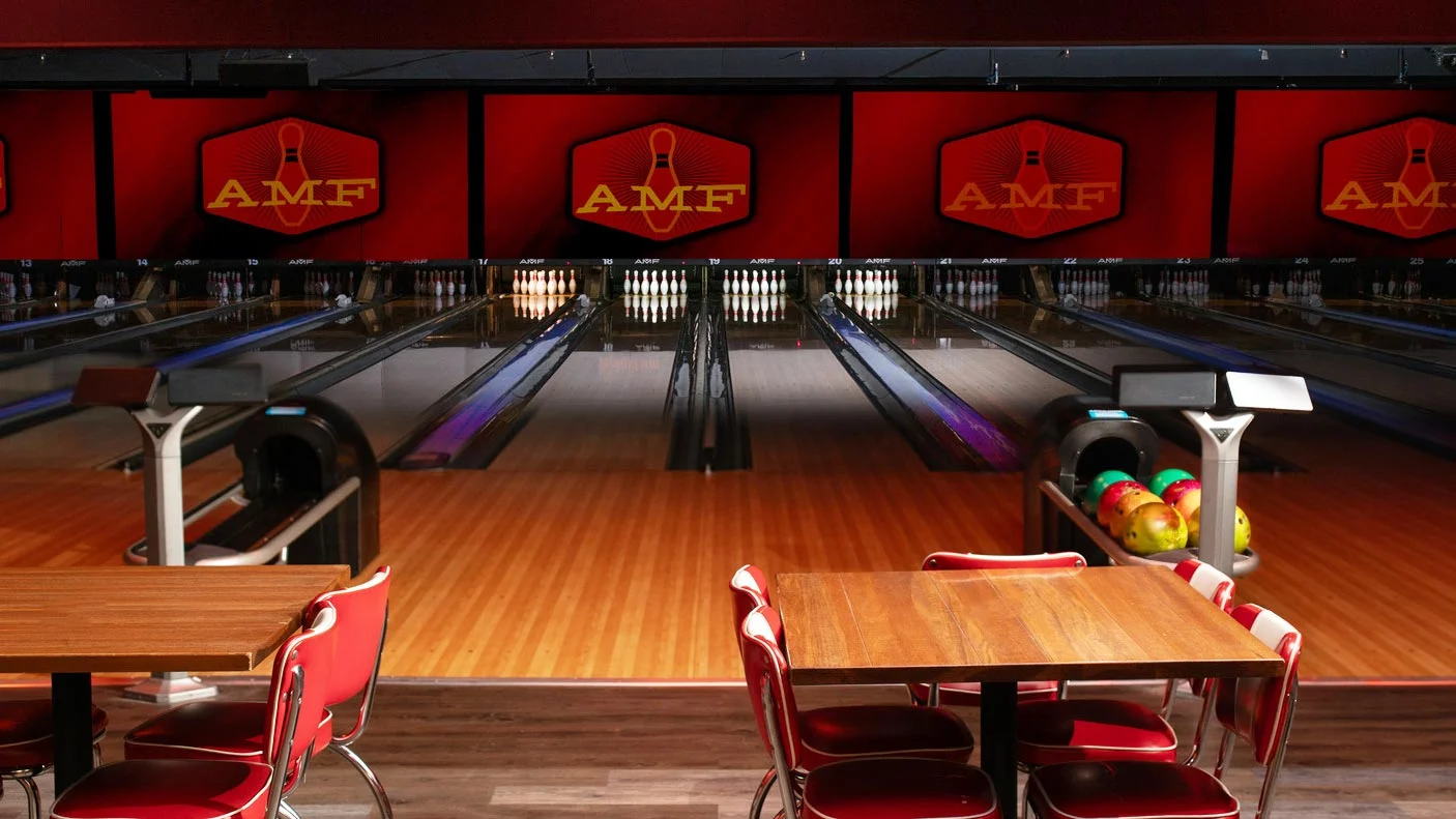Classic AMF bowling lanes with tables and seating, ideal for group outings and casual games.