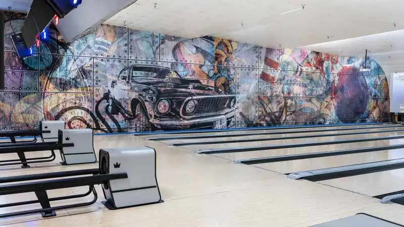 Beautiful, well-maintained bowling lanes with a huge mural in the background.