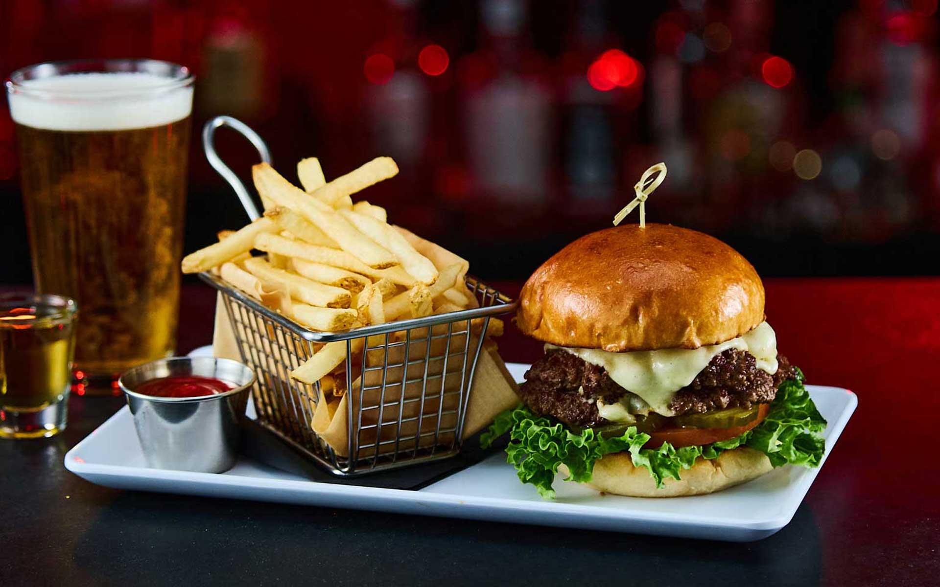Double burger with basket of french fries and ketchup.