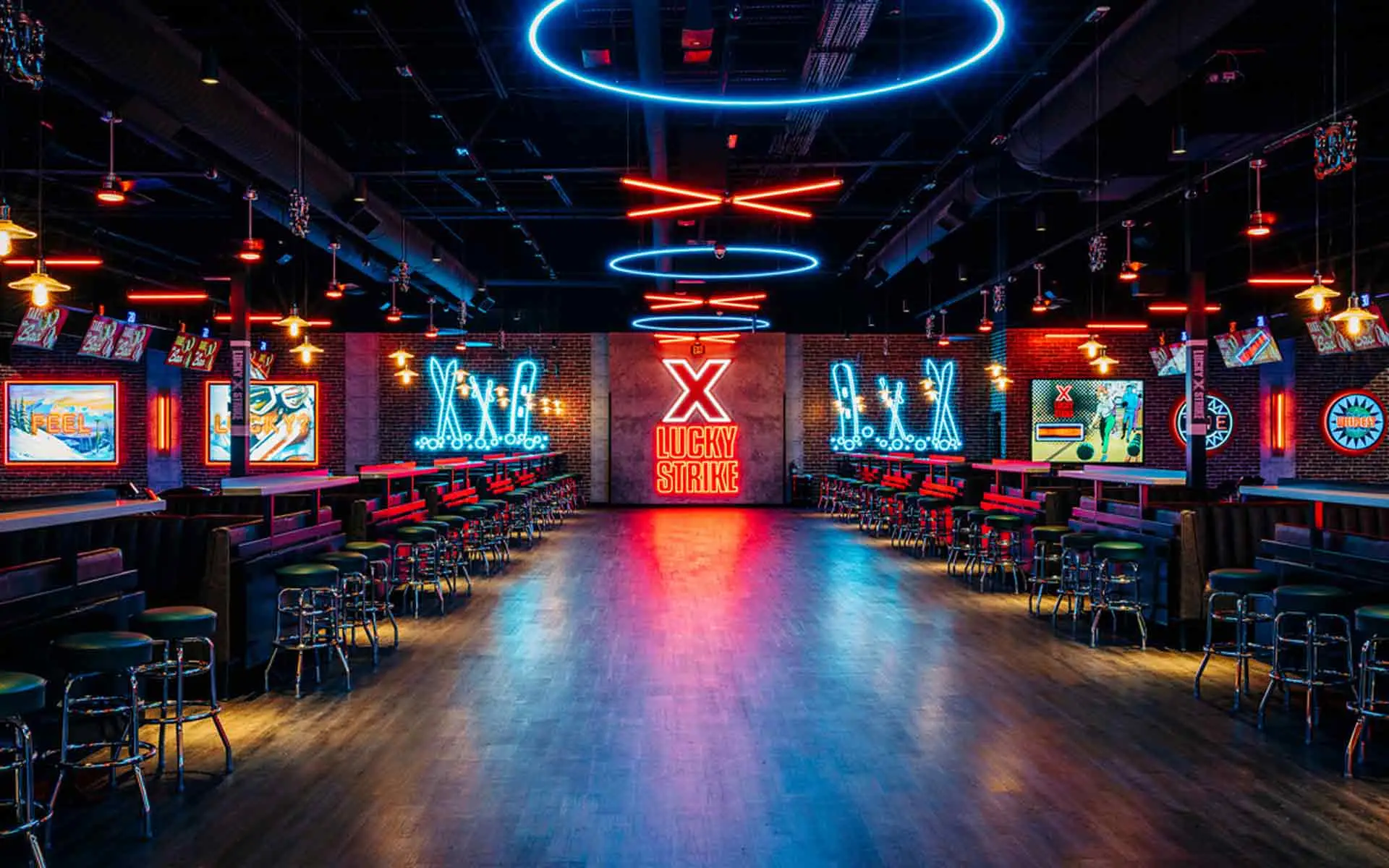 Bowling lanes with Get Lucky neon wall mural and Lucky Strike branded signage at Lucky Strike Southlands