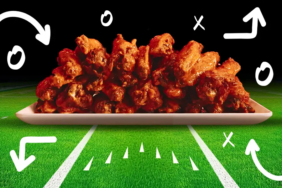 Delicious stack of chicken wings on a football field