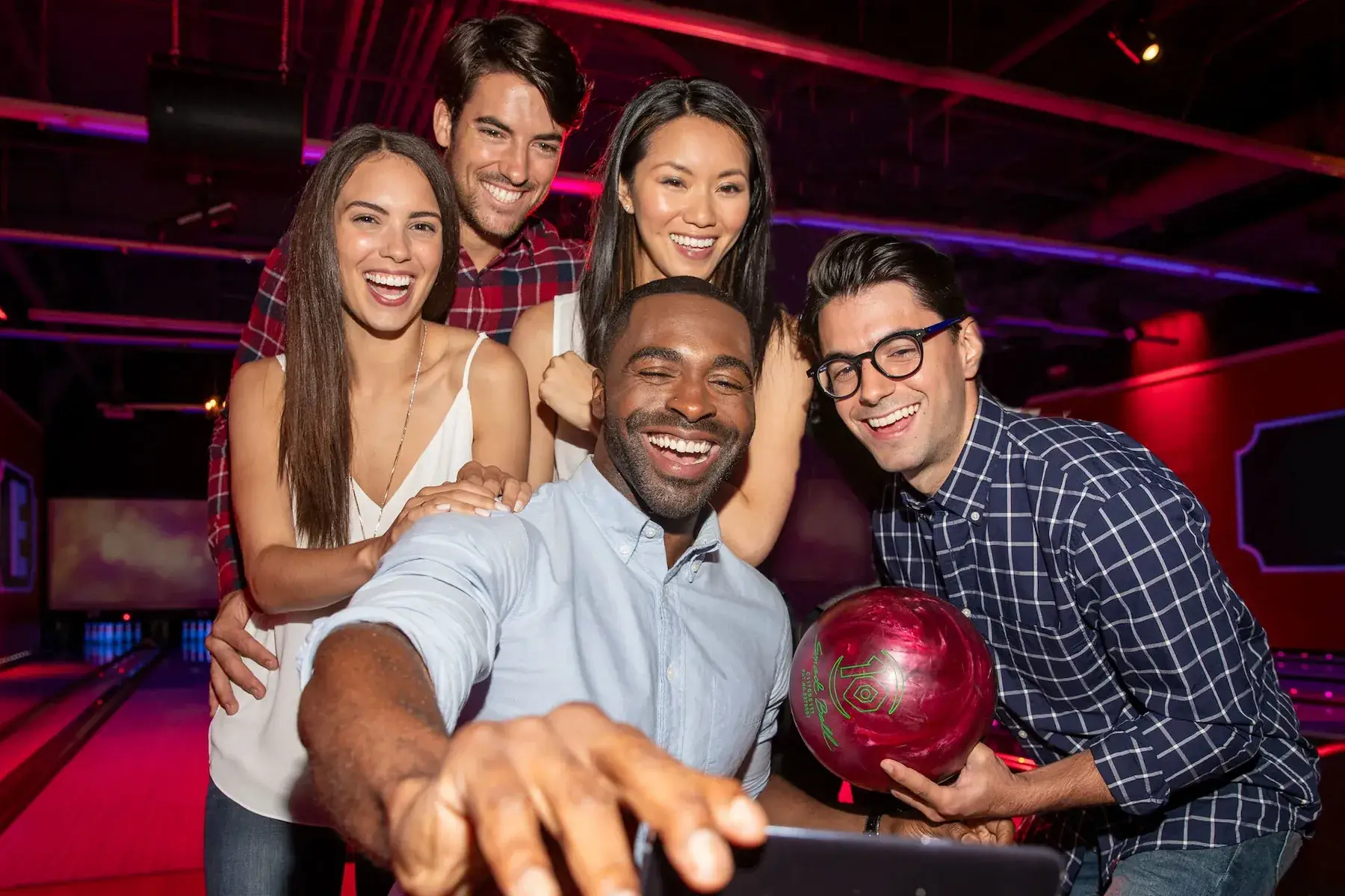 A group of employees taking a selfie on the lanes. 