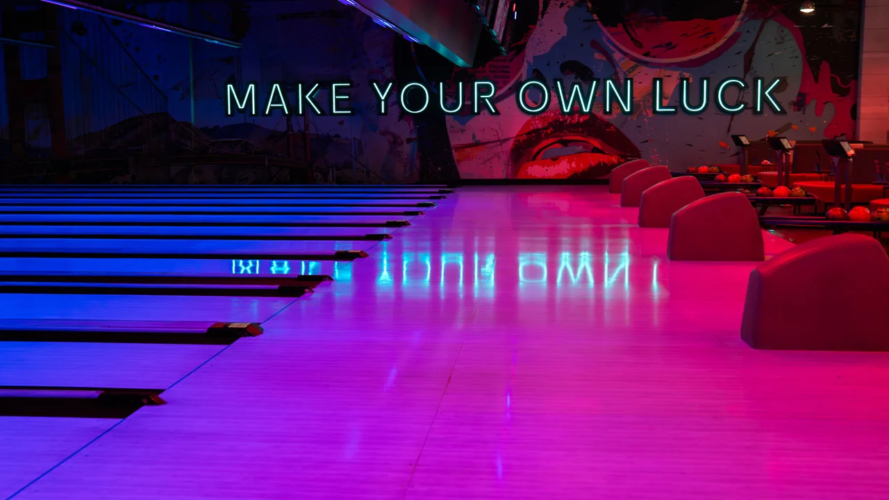 Beautiful bowling lanes with black lights and large mural in the background