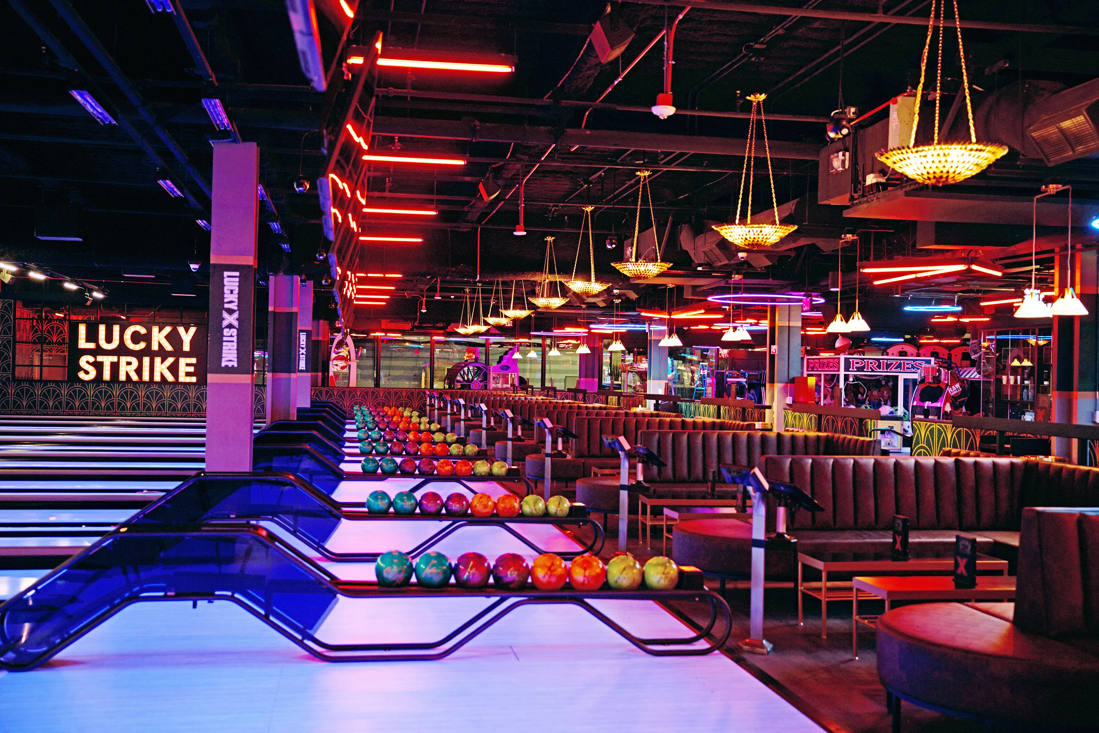 Modern bowling lanes at Lucky Strike featuring luxury seating, colorful lighting, and a high-energy entertainment space.