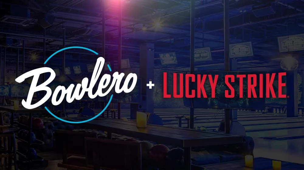 Bowlero and Lucky Strike co-brand graphic with both logos over a dimly lit, upscale bowling alley interior with glowing lanes and overhead screens.