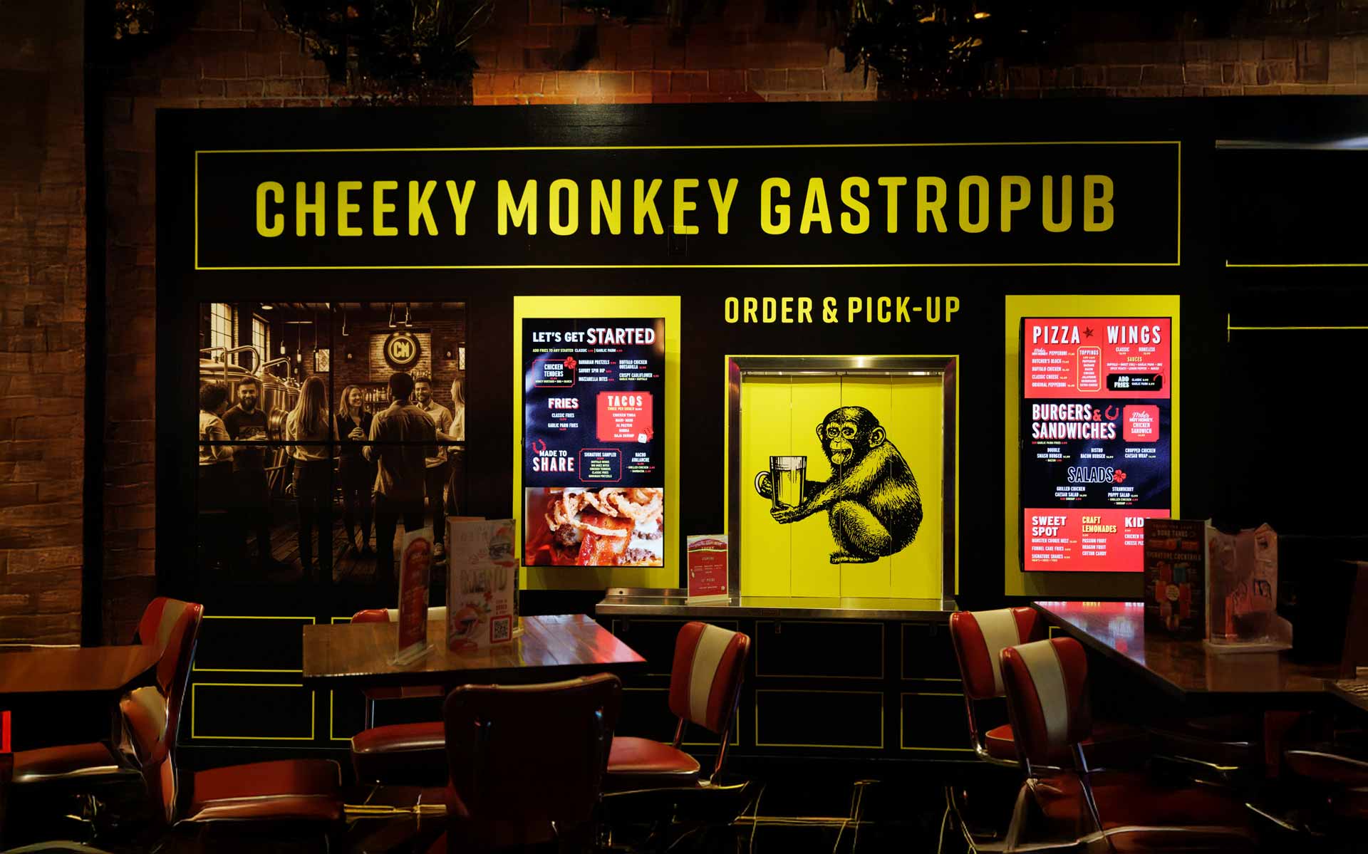Bold, modern dining concept with striking black-and-yellow branding and a playful identity. Offers counter-service ordering with a menu of elevated bar food, including burgers, wings, pizza, and shareables in a stylish, casual setting.