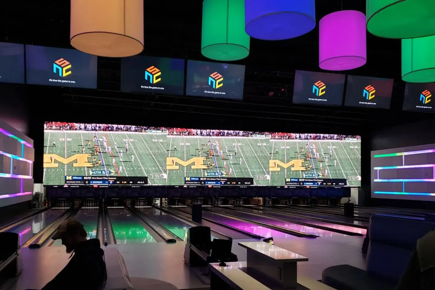 Bowling lanes with large television monitors above the lanes