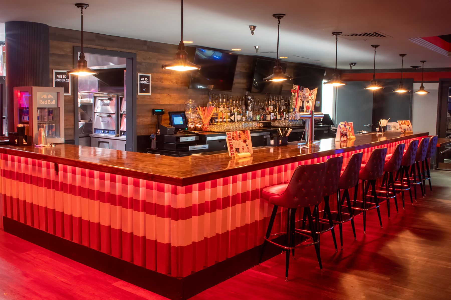 Classic bar with lots of stools and big TVs