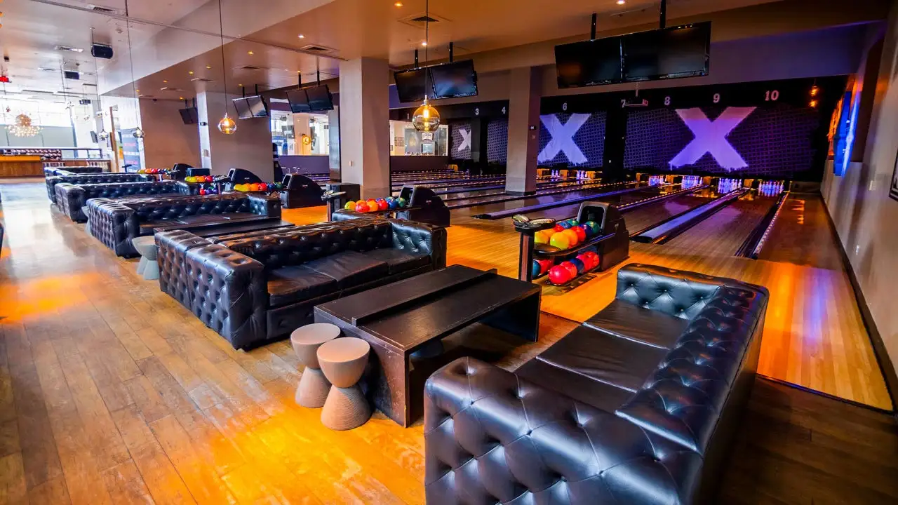 Beautiful bowling lanes with spacious and comfortable lounge-style leather couches.