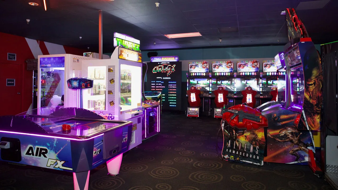 Large and colorful arcade games in a beautiful arcade room.