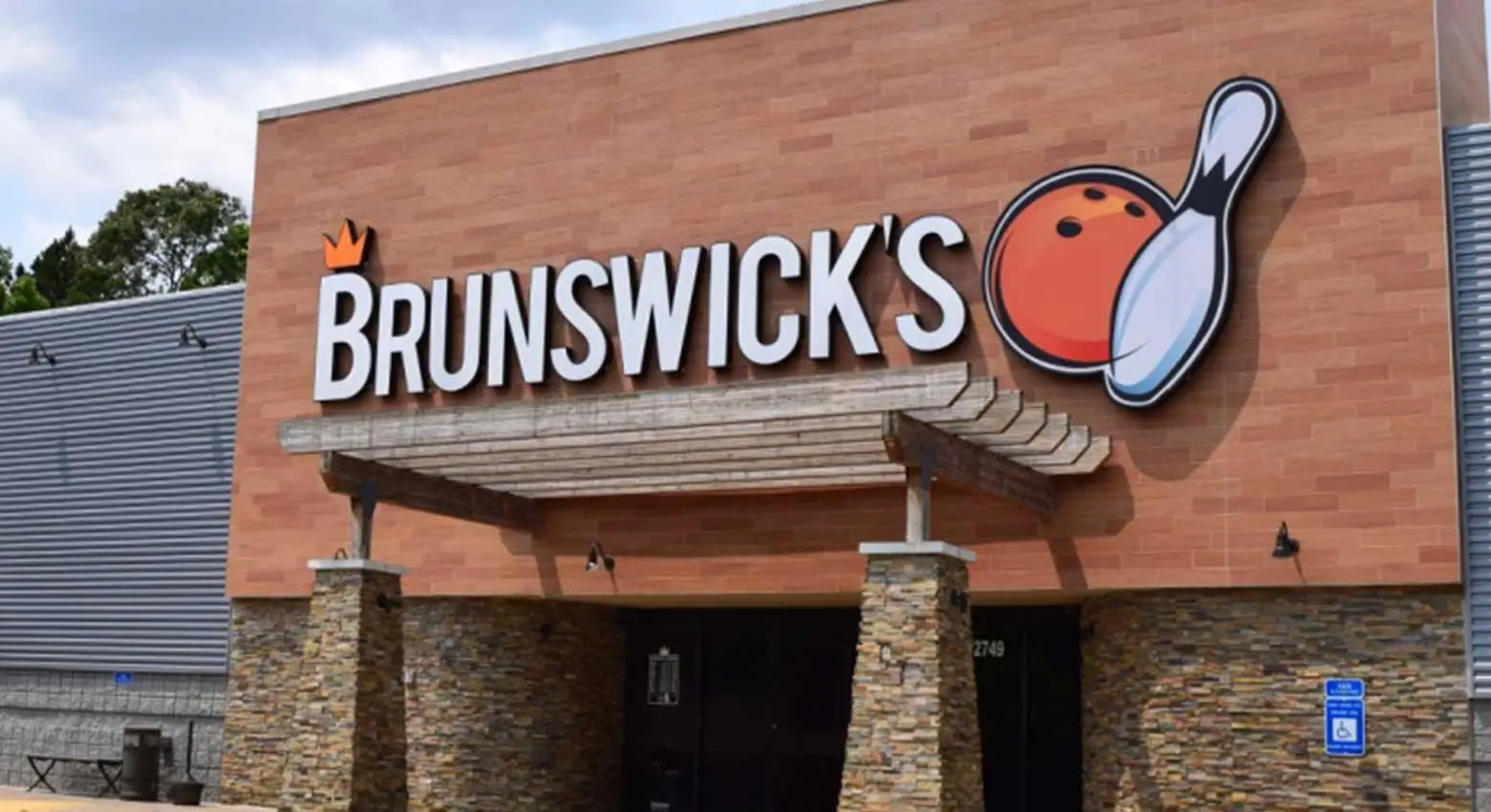 Exterior of a Brunswick bowling center with large bowling pin signage and a brick facade.