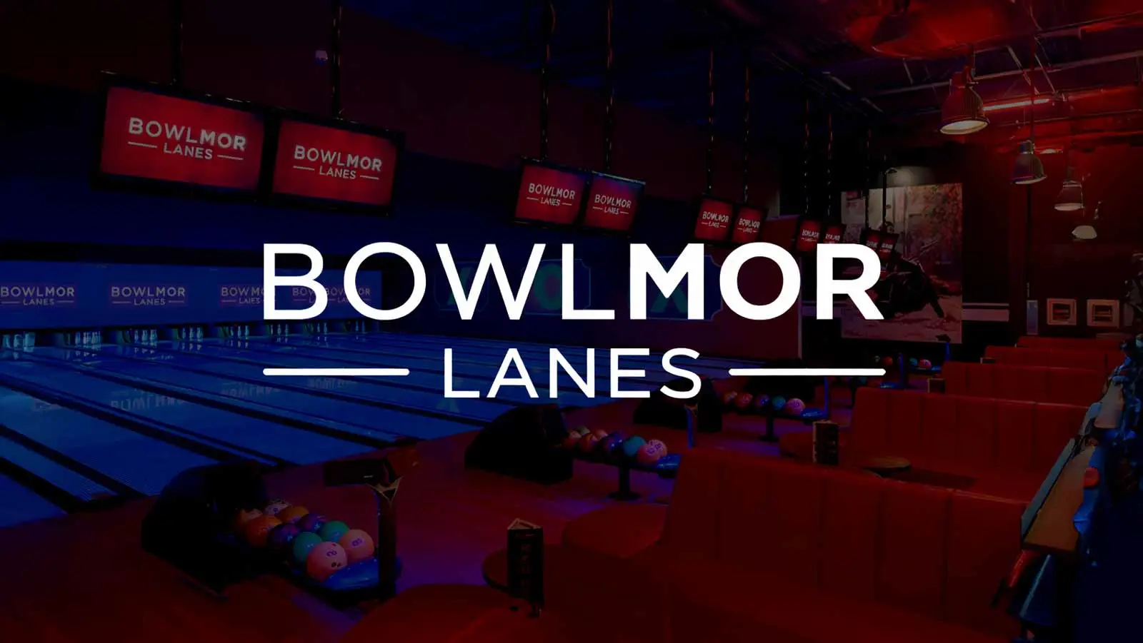 Bowlmor Lanes logo over a modern bowling alley interior with illuminated lanes, overhead screens, and red lounge seating.