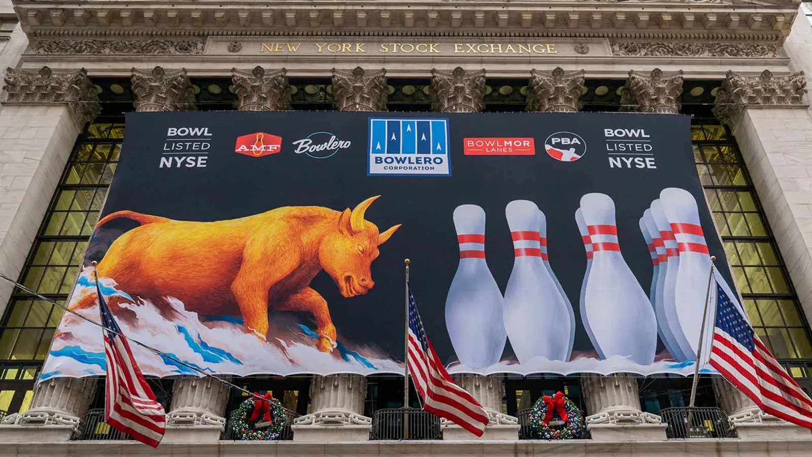 Large Bowlero Corporation banner displayed on the New York Stock Exchange featuring bowling pins, a charging bull illustration, and AMF, Bowlero, Bowlmor, and PBA logos.
