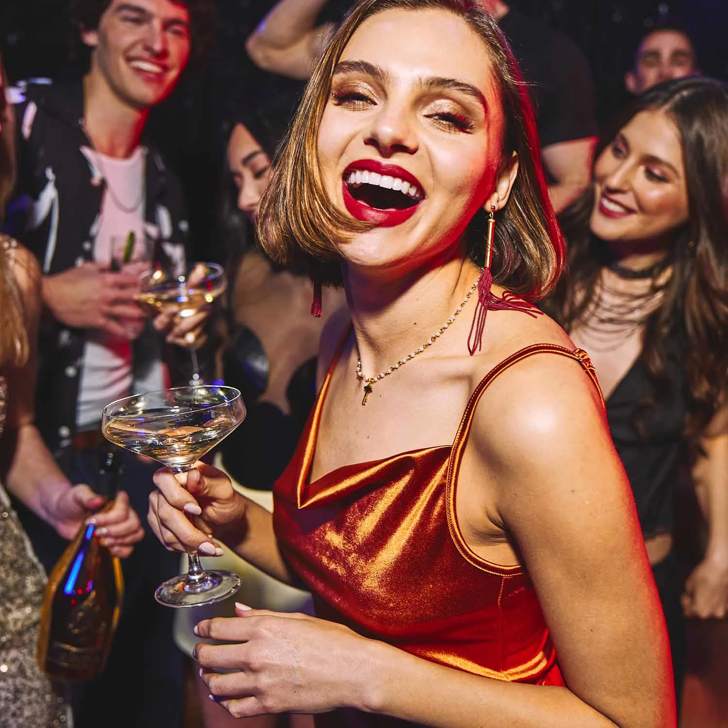 Woman enjoying champagne at Lucky Strike party.