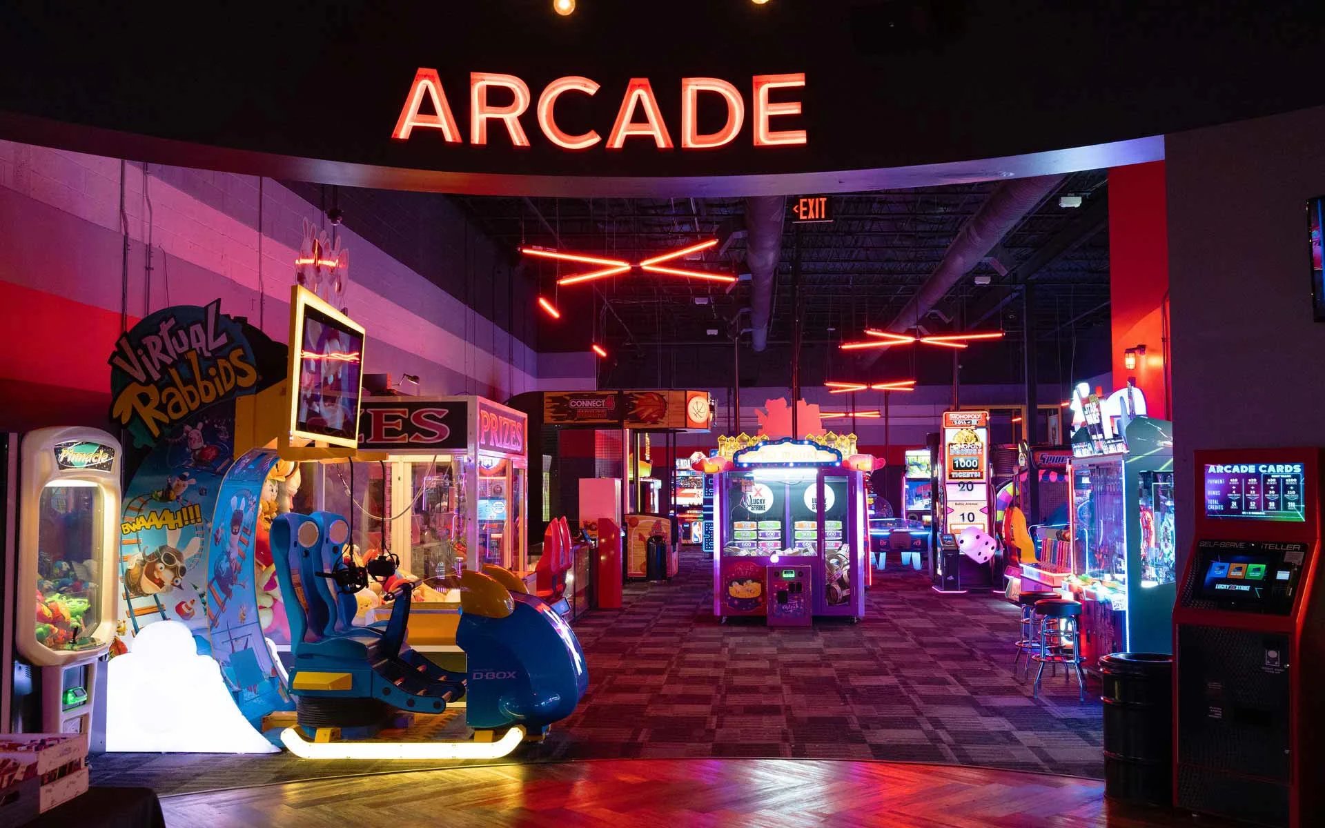 Neon “Arcade” entrance at Lucky Strike featuring colorful game machines, prize stations, and immersive lighting in a modern entertainment venue.