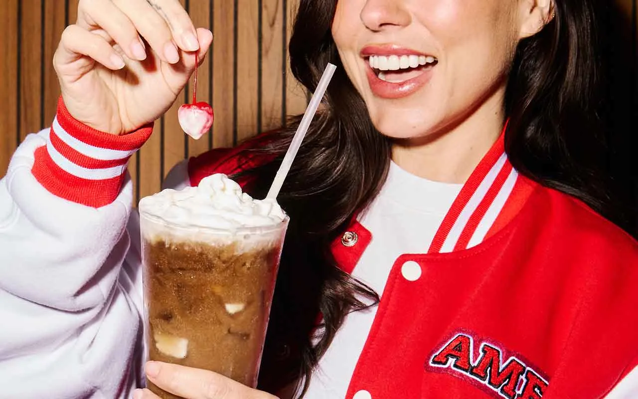 Creamy dirty soda topped with whipped cream and a cherry, served at AMF Bowling as part of the venue's food and drink menu.