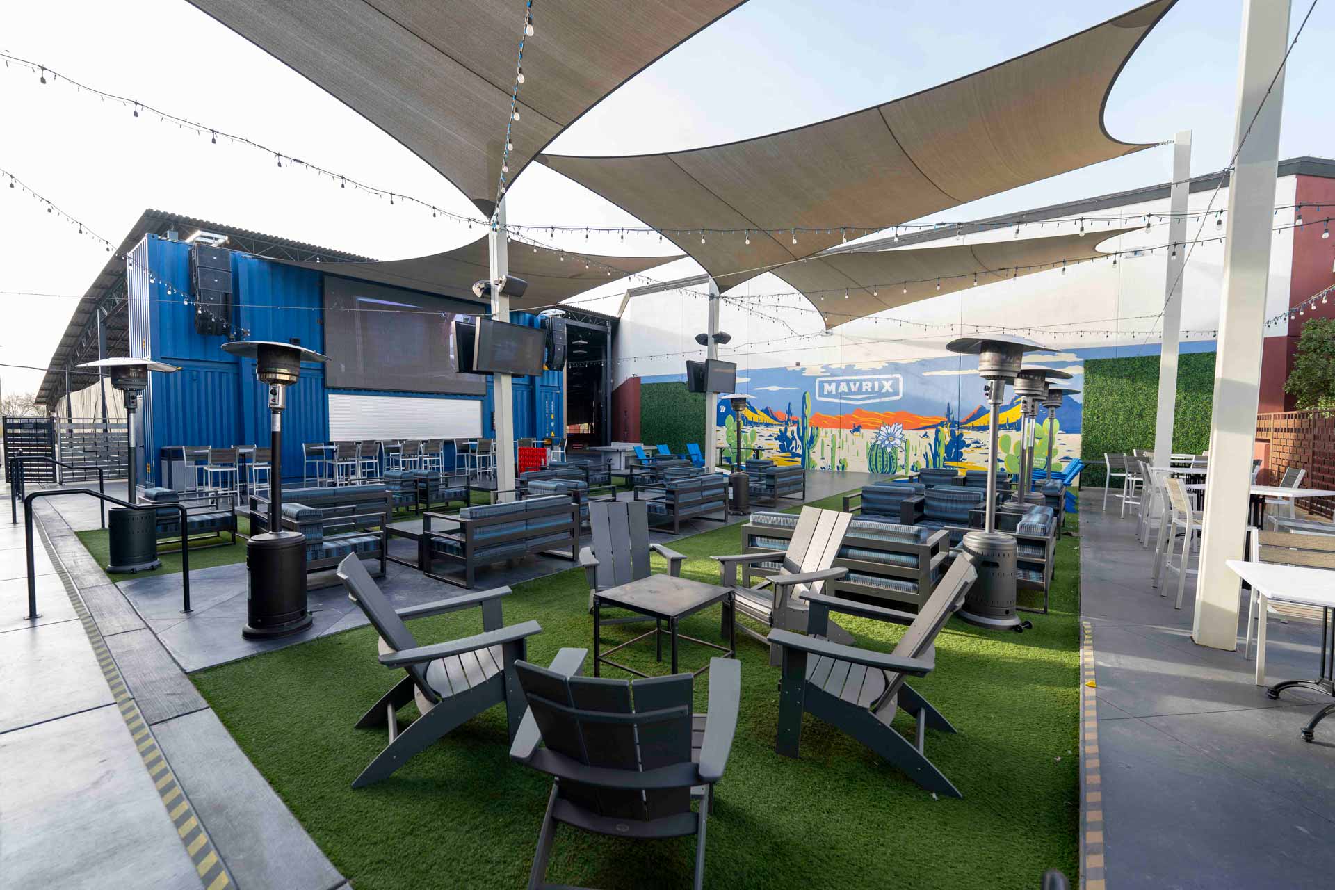 Outdoor patio seating area at Mavrix Entertainment Center with shaded canopies and lounge furniture.