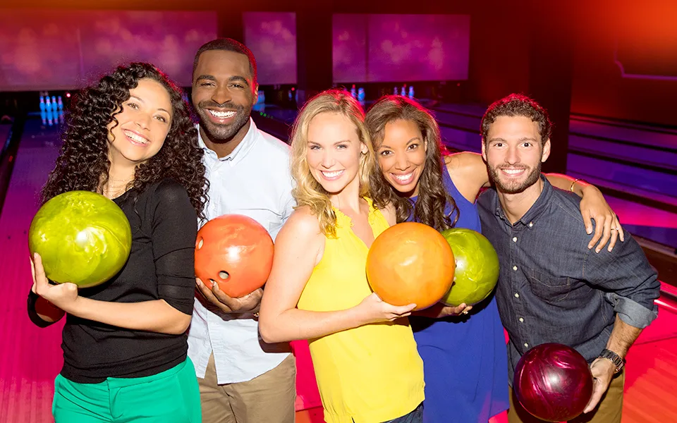 Group of bowlers holding bowling balls